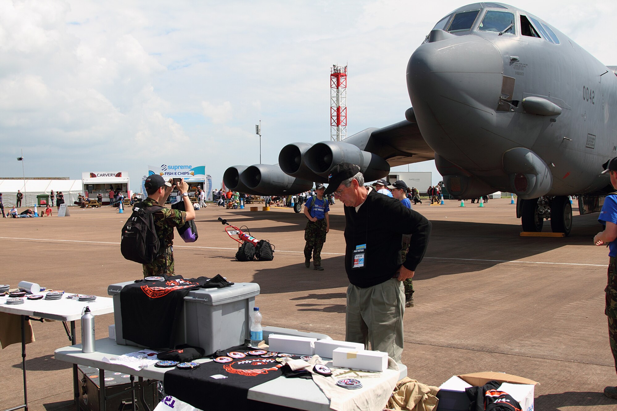 A young man takes a photo of a B-52 Stratofortress at the Royal International Air Tattoo 2012, RAF Fairford, England, July 8, 2012. An aircrew and B-52 Stratofortress from the 93rd Bomb Squadron, 307th Bomb Wing were on hand at what is touted as the world’s biggest military air show from July 4-9, 2012. (Courtesy photo by Roel Reijne)