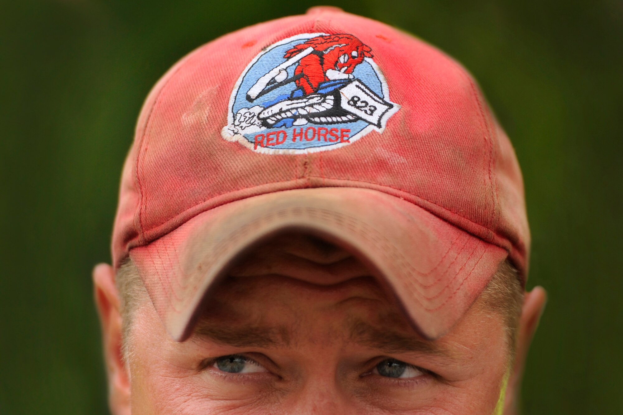 A U.S. Air Force Staff Sgt. Randall Mccunegould, 823rd RED HORSE Squadron, wears his squadron hat signifying his assignment to the 823rd RHS while working on a repaving project at Shaw Air Force Base, S.C., July 12, 2012. The 823rd RHS is one of the few units who are authorized to wear unit hats in uniform. The 823rd RHS is an Air Combat Command asset assigned to the Ninth Air Force that operates out of Hurlburt Field, Fla. RED HORSE stands for Rapid Engineer Deployable Heavy Operational Repair Squadron Engineer. (U.S. Air Force photo by Senior Airman Kenny Holston/Released) 