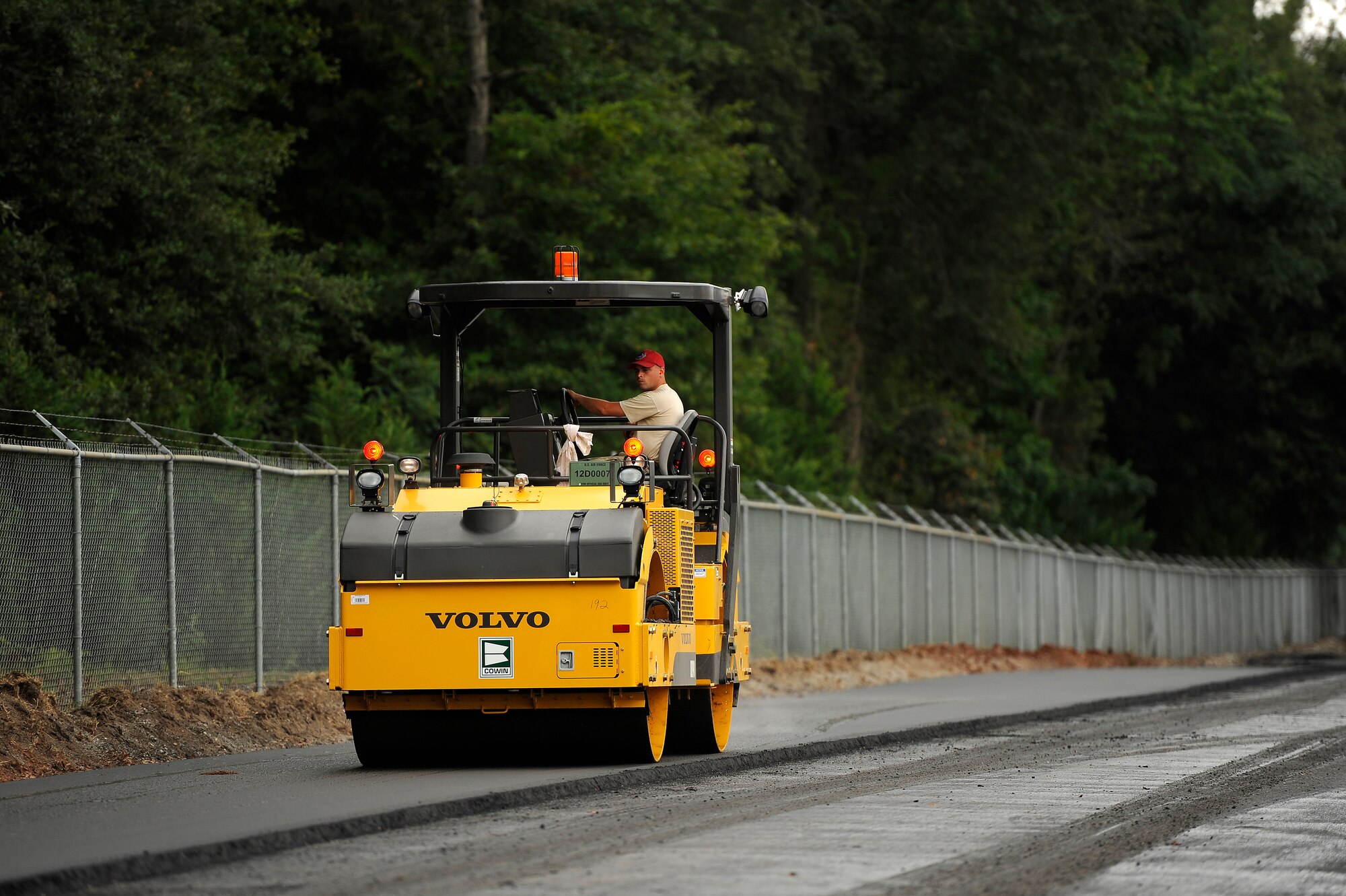 A U.S. Air Force Senior Airman Joseph Chalkley 823rd RED HORSE Squadron pavement and construction specialist, steam rolls freshly laid asphalt on Aiken Street, Shaw Air Force Base, S.C., July 12, 2012. A team of 21 Airmen assigned to the 823rd RHS are slated to repave just over a mile of Shaw roadway. The 823rd RHS is an Air Combat Command asset assigned to the Ninth Air Force that operates out of Hurlburt Field, Fla. RED HORSE stands for Rapid Engineer Deployable Heavy Operational Repair Squadron Engineer. (U.S. Air Force photo by Senior Airman Kenny Holston/Released)  
