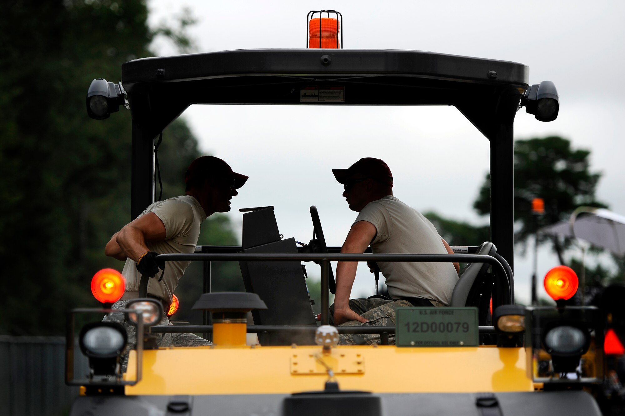 U.S. Air Force Tech Sgt. Obie Oglesby, (left) and Senior Airman Joseph Chalkley, both assigned to the 823rd RED HORSE Squadron, discuss the next steps to take on their project of repaving Aiken Street, Shaw Air Force Base, S.C., July 12, 2012. The 823rd RHS Airmen broke ground June 29 which began a $363,000 project of repaving just over a mile of Shaw’s roadway. The 823rd RHS is an Air Combat Command asset assigned to the Ninth Air Force that operates out of Hurlburt Field, Fla. RED HORSE stands for Rapid Engineer Deployable Heavy Operational Repair Squadron Engineer. (U.S. Air Force photo by Senior Airman Kenny Holston/Released)  