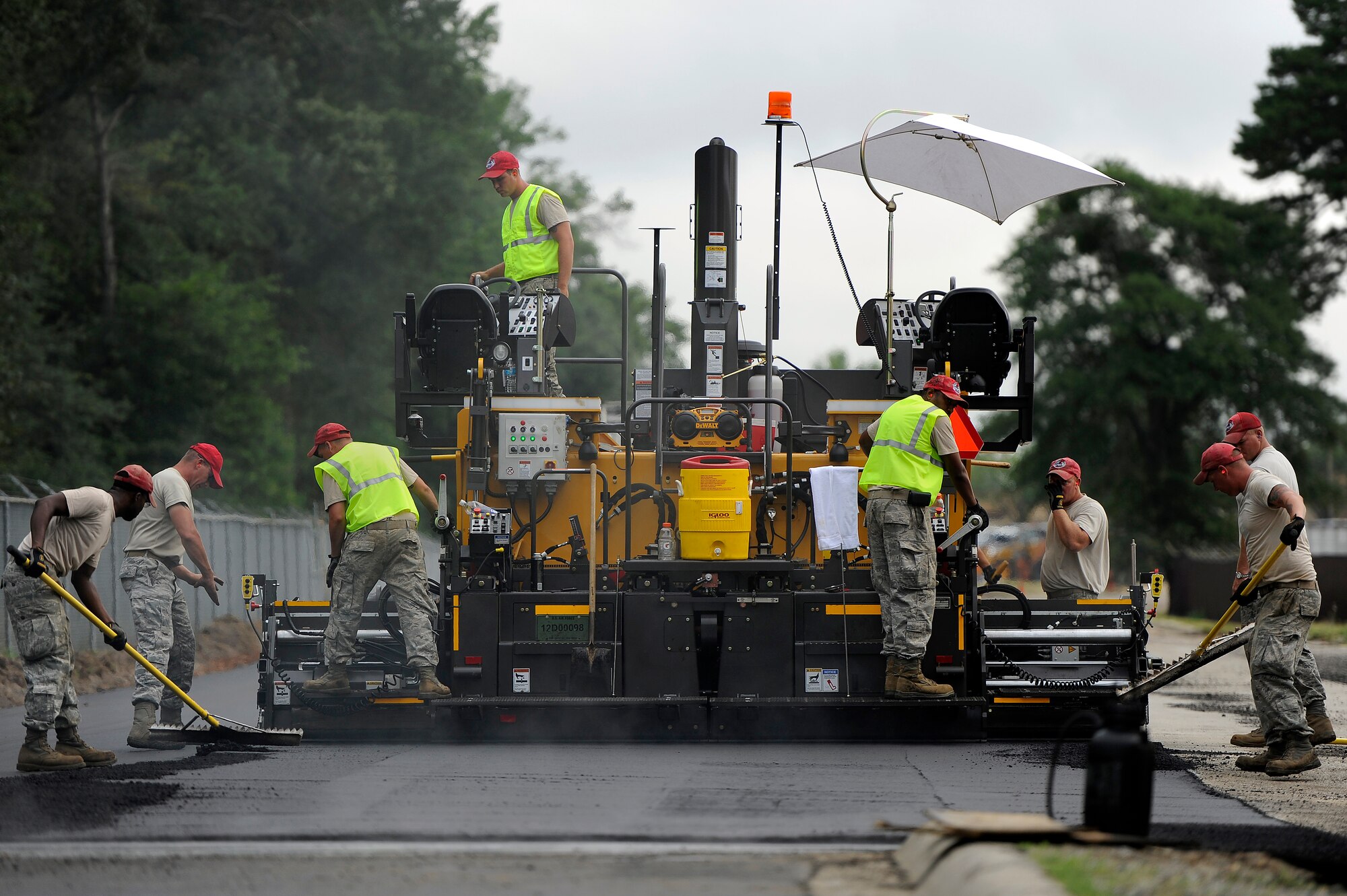 U.S. Air Force Airmen assigned to the 823rd RED HORSE Squadron, work together to repave Aiken Street, Shaw Air Force Base, S.C., July 12, 2012.  The 823rd RHS Airmen broke ground June 29 which began a $363,000 project of repaving just over a mile of Shaw’s roadway. The 823rd RHS is an Air Combat Command asset assigned to the Ninth Air Force that operates out of Hurlburt Field, Fla. RED HORSE stands for Rapid Engineer Deployable Heavy Operational Repair Squadron Engineer. (U.S. Air Force photo by Senior Airman Kenny Holston/Released)  