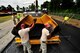 U.S. Air Force Senior Airman Ahl Raym Tolrio and Senior Airman Malcolm Stone, both assigned to the 823rd RED HORSE Squadron, sift asphalt as it being laid on Aiken Street, Shaw Air Force Base, S.C., July 12, 2012. The 823rd RHS Airmen broke ground June 29 beginning a $363,000 project of repaving just over a mile of Shaw’s roadway. The 823rd RHS is an Air Combat Command asset assigned to the Ninth Air Force that operates out of Hurlburt Field, Fla. RED HORSE stands for Rapid Engineer Deployable Heavy Operational Repair Squadron Engineer. (U.S. Air Force photo by Senior Airman Kenny Holston/Released) 