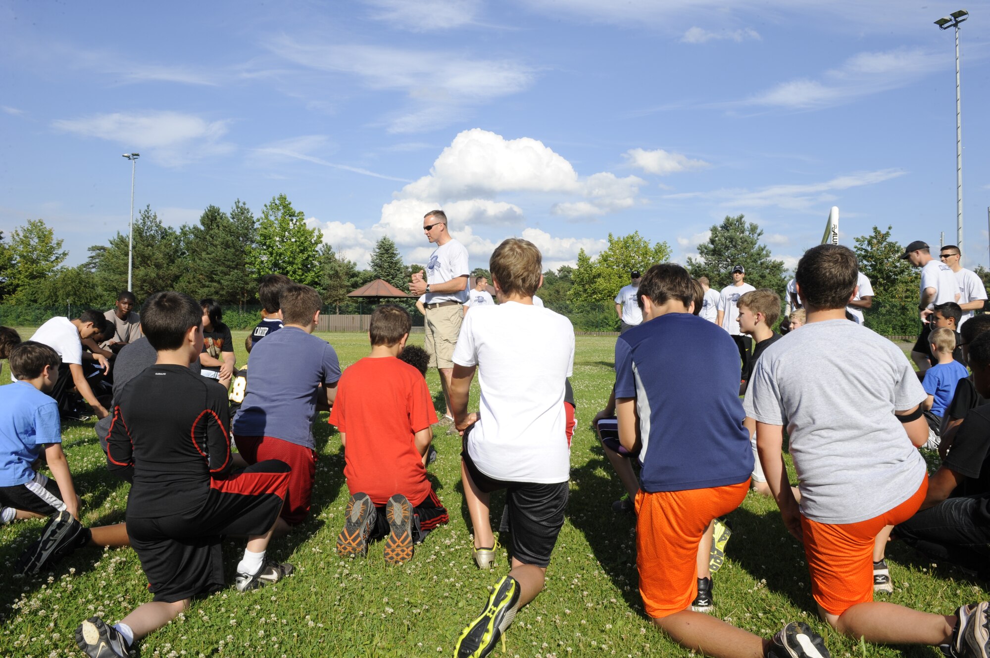 Athletes at the youth football camp practice different drills improving their abilities on Ramstein Air Base, Germany, July 10, 2012. The camp is geared toward teaching  participants teamwork and football techniques. (U.S. Air Force photo/ Senior Airman Aaron-Forrest Wainwright)
