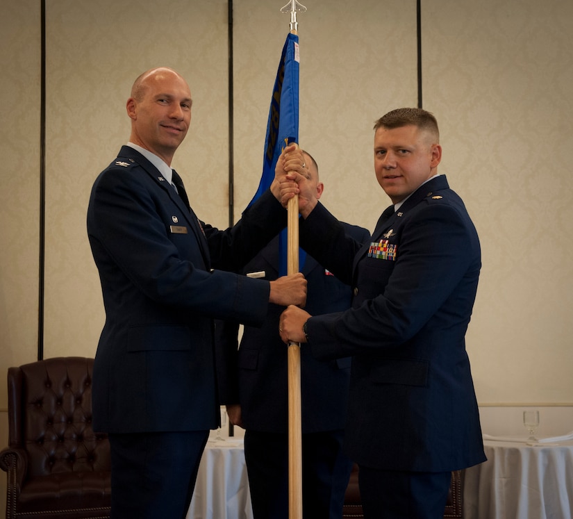 Col. Justin Davey, 628th Mission Support Group commander, hands the squadron guidon to Major Joseph Wingo, 628th Communications Squadron incoming commander, during the 628th CS Change of Command ceremony at Joint Base Charleston - Air Base, S.C. July 13, 2012. (U.S. Air Force photo/Airman 1st Class Ashlee Galloway)

