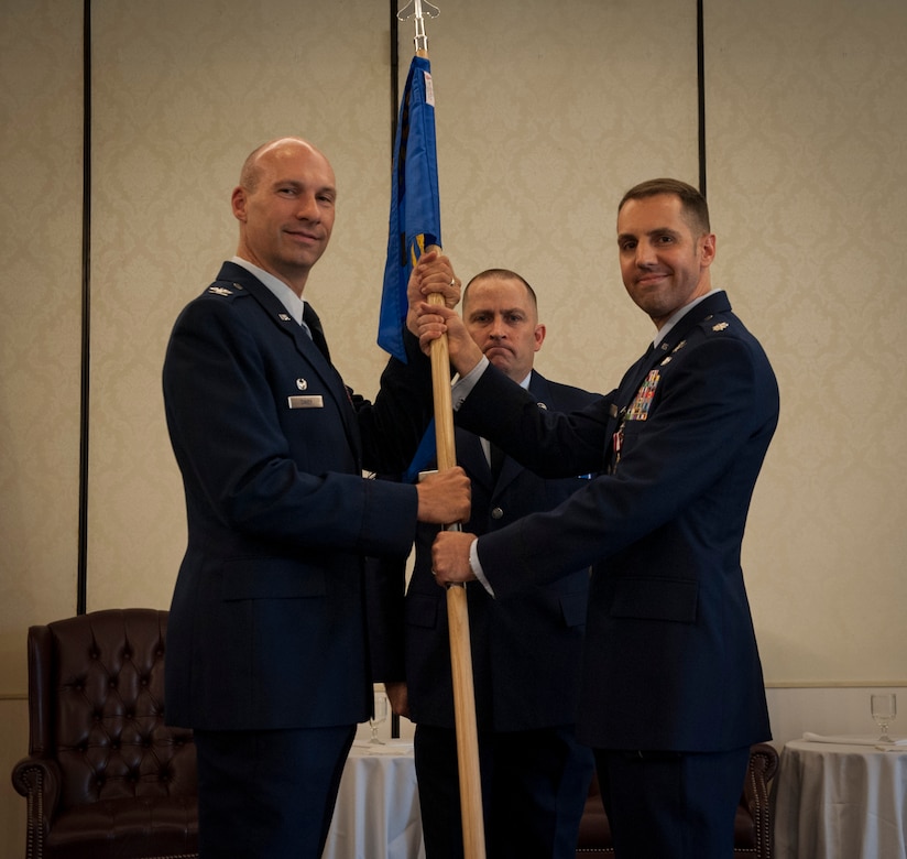 Colonel Justin Davey, 628th Mission Support Group commander, takes the squadron guidon from Lt. Col. David Joerres, 628th Communications Squadron commander, during the 628th CS Change of Command ceremony at Joint Base Charleston - Air Base, S.C. July 13, 2012. (U.S. Air Force photo/Airman 1st Class Ashlee Galloway)