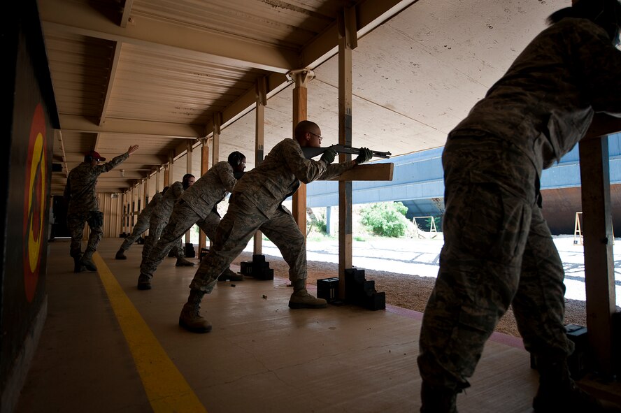Members of 7th Security Forces Squadron prepare to shoot a MCS 870 shotgun during the qualification portion of the shotgun course July 13, 2012, at Dyess Air Force Base, Texas. To qualify, Airmen must shoot five rounds from the shotgun and have 25 of 45 pellets on a target 25 meters away, while shooting in the standing, over barricade and standing barricade position. The MCS 870 shotgun is a 12-gauge, pump action, manually operated, tubular magazine, internal hammered, air-cooled, shoulder fired weapon used for close-quarter-combat. The shotgun is also capable of being loaded with lethal and non-lethal rounds making it ideal for breaching and riot control. (U.S. Air Force photo by Airman 1st Class Damon Kasberg/Released)