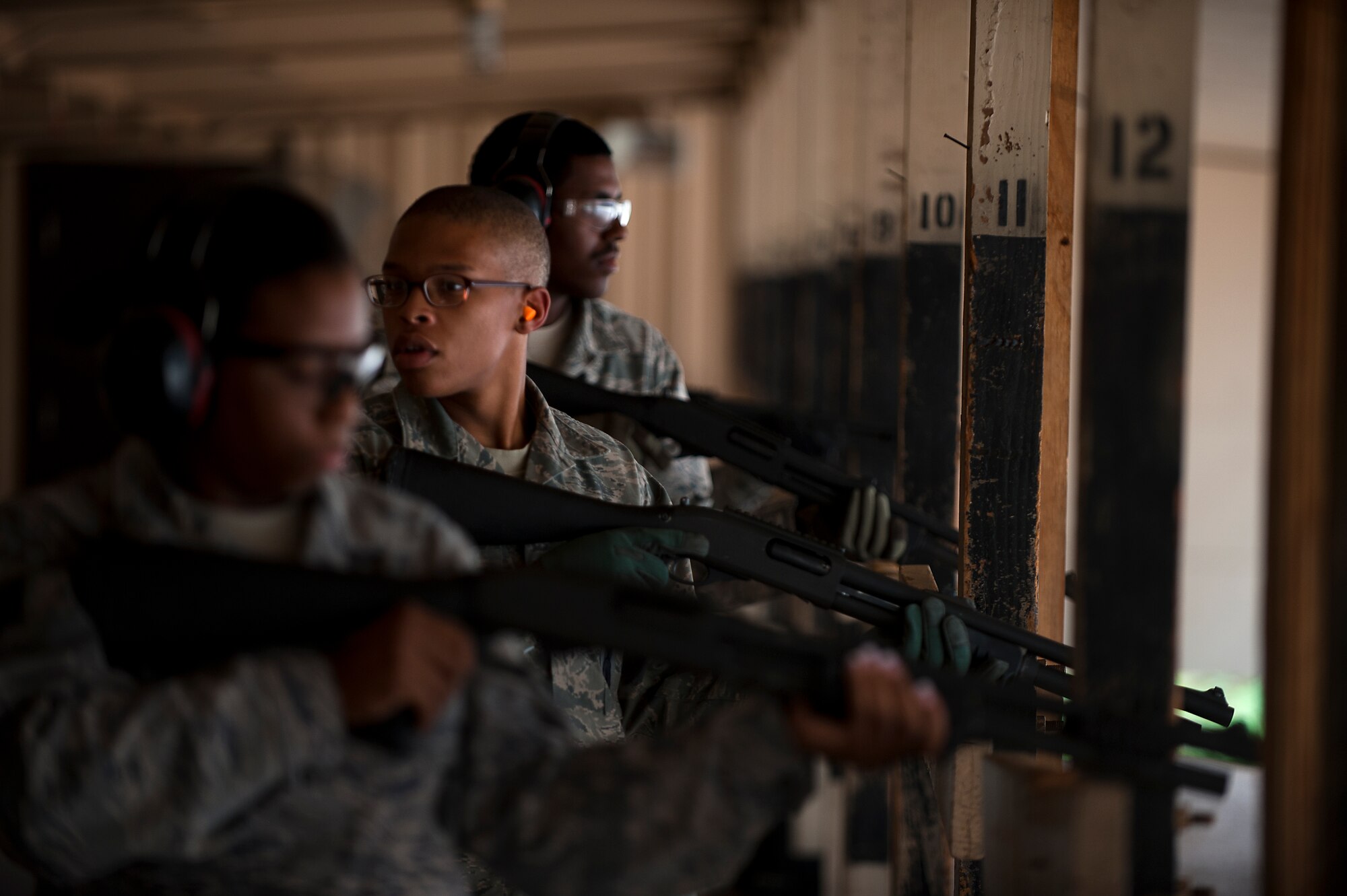 Members of 7th Security Forces Squadron prepare to shoot a MCS 870 shotgun during the qualification portion of the shotgun course July 13, 2012, at Dyess Air Force Base, Texas. To qualify, Airmen must shoot five rounds from the shotgun and have 25 of 45 pellets on a target 25 meters away, while shooting in the standing, over barricade and standing barricade position. The MCS 870 shotgun is a 12-gauge, pump action, manually operated, tubular magazine, internal hammered, air-cooled, shoulder fired weapon used for close-quarter-combat. The shotgun is also capable of being loaded with lethal and non-lethal rounds making it ideal for breaching and riot control. (U.S. Air Force photo by Airman 1st Class Damon Kasberg/Released)