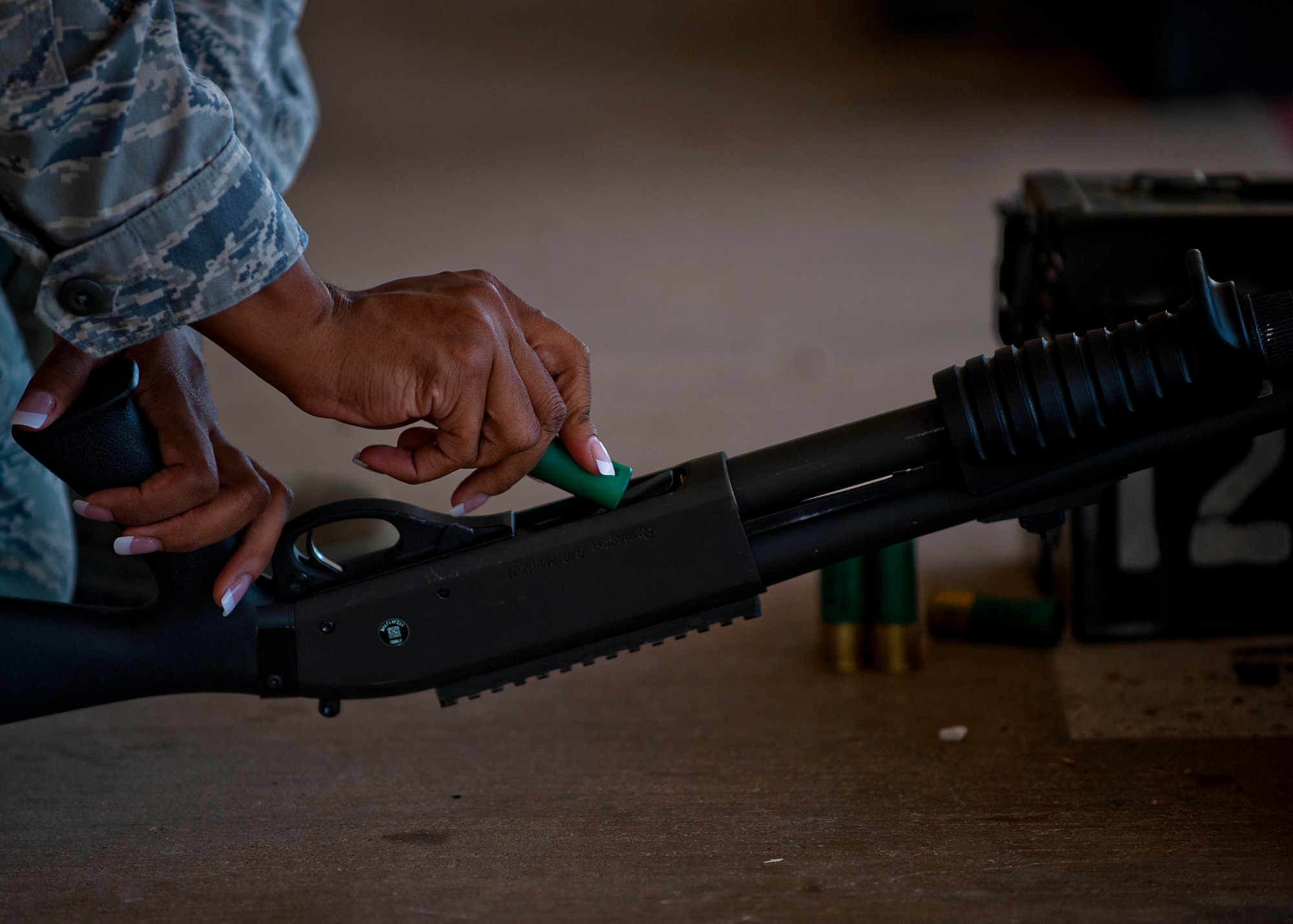 U.S. Air Force Staff Sgt. Lenice McLean, 7th Security Forces Squadron, reloads a MCS 870 shotgun during the qualification portion of the shotgun course July 13, 2012, at Dyess Air Force Base, Texas. To qualify, Airmen must shoot five rounds from the shotgun and have 25 of 45 pellets on a target 25 meters away, while shooting in the standing, over barricade and standing barricade position. The MCS 870 shotgun is a 12-gauge, pump action, manually operated, tubular magazine, internal hammered, air-cooled, shoulder fired weapon used for close-quarter-combat. The shotgun is also capable of being loaded with lethal and non-lethal rounds making it ideal for breaching and riot control. (U.S. Air Force photo by Airman 1st Class Damon Kasberg/Released)