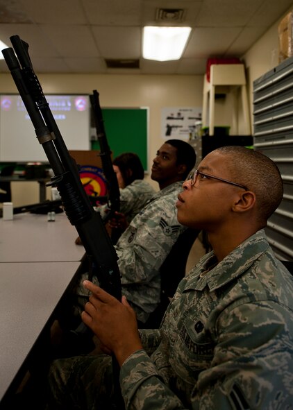 Airman 1st Class Raymond Thompkins, 7th Security Forces Squadron, participates in the classroom portion of a qualification course for the MCS 870 shotgun July 13, 2012, at Dyess Air Force Base, Texas. During the classroom segment, Airmen learned how to handle, reload, disassemble and reassemble their weapon. The MCS 870 shotgun is a 12-gauge, pump action, manually operated, tubular magazine, internal hammered, air-cooled, shoulder fired weapon used for close-quarter-combat. The shotgun is also capable of being loaded with lethal and non-lethal rounds making it ideal for breaching and riot control.  (U.S. Air Force photo by Airman 1st Class Damon Kasberg/Released)