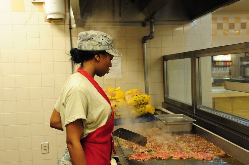 Airman 1st Class Ashli Green, 437th Force Support Squadron journeyman, grills hamburgers at Joint Base Charleston – Air Base, S.C., Gaylor Dining Facility, July 10, 2012. The Gaylor Dining facility supports the 437th and 315th Airlift Wings and the 628th Air Base Wing by providing more than 211,000 hot, nutritious meals annually. (U.S. Air Force photo/ Airman 1st Class Chacarra Walker)