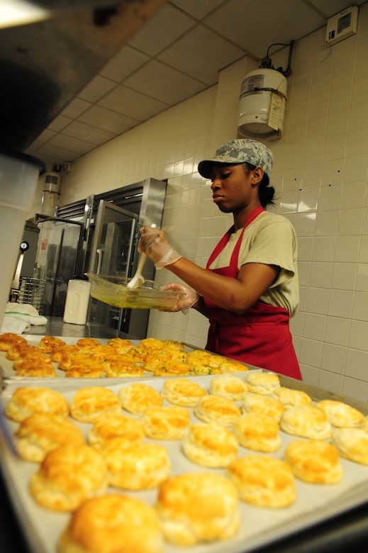 Airman 1st Class Ashli Green, 437th Force Support Squadron journeyman, butters biscuits at the Joint Base Charleston – Air Base, S.C., Gaylor Dining Facility, July 10, 2012. The Gaylor Dining Facility supports the 437th and 315th Airlift Wings and the 628th Air Base Wing by providing more than 211,000 hot, nutritious meals annually. (U.S. Air Force photo/ Airman 1st Class Chacarra Walker)