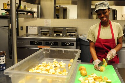 Airman 1st Class Ashli Green, 437th Force Support Squadron food services journeyman, cuts potatoes at the Gaylor Dining Facility at Joint Base Charleston – Air Base, S.C., July 9, 2012. The Gaylor Dining Facility serves enlisted and retired military members cafeteria-style and self-serve meals. The modern facility has a full-service snack and main-entrée line, as well as a full salad and dessert bar.  In addition to serving breakfast, lunch and dinner, the dining facility offers a midnight meal for Airmen who work shifts.   (U.S. Air Force photo/ Airman) 1st Class Chacarra Walker)