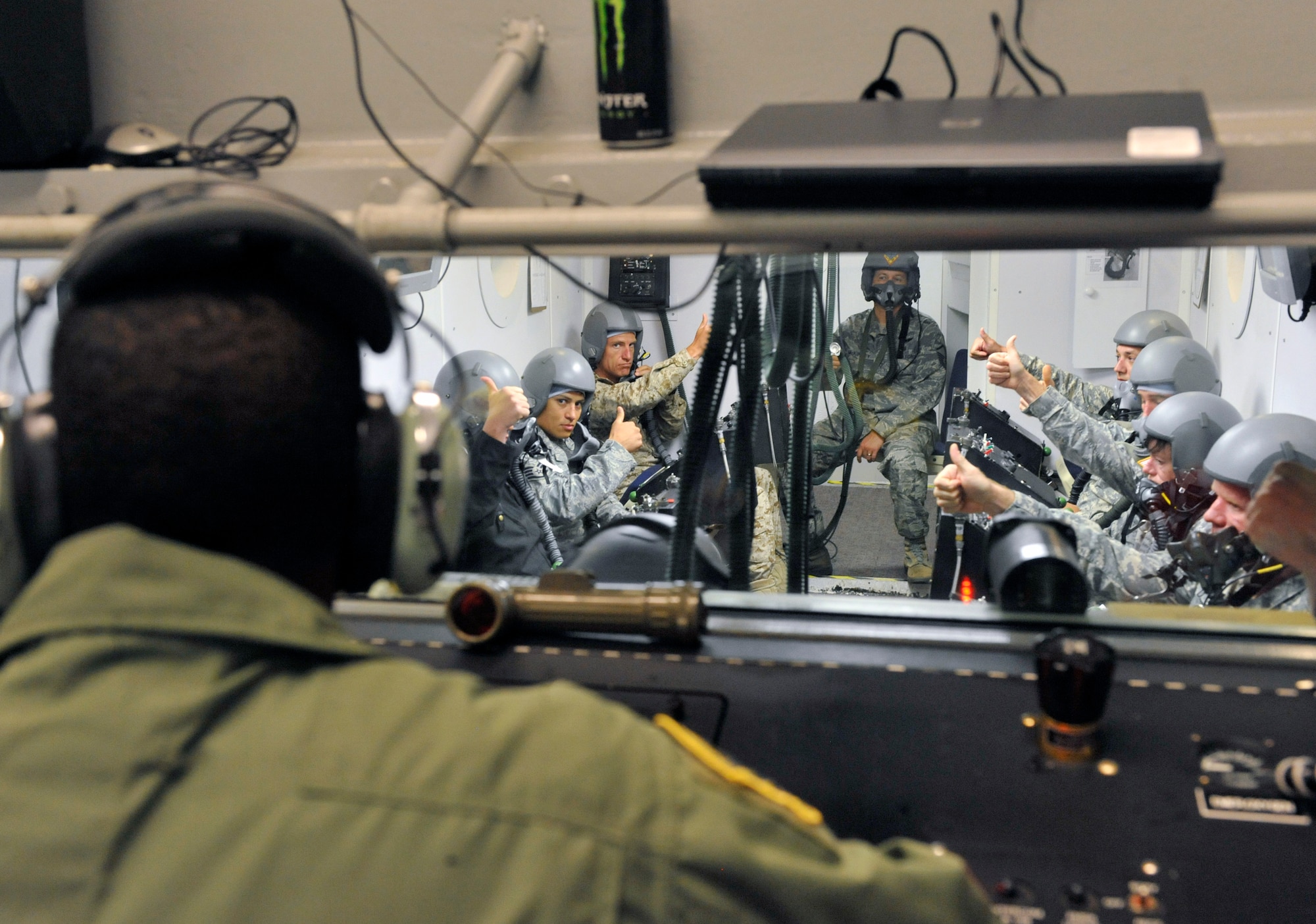 U.S. Air Force Airman 1st Class Earnest Powell, 20th Aerospace Medicine Squadron aerospace and operational physiology technician, asks students for feedback during a chamber flight at Shaw Air Force Base, S.C., July 10, 2012. The five hour long high altitude parachute course consisted of a four hour classroom lecture and one hour chamber flight in a hypobaric chamber. (U.S. Air Force photo by Senior Airman Amber E. N. Jacobs/Released)