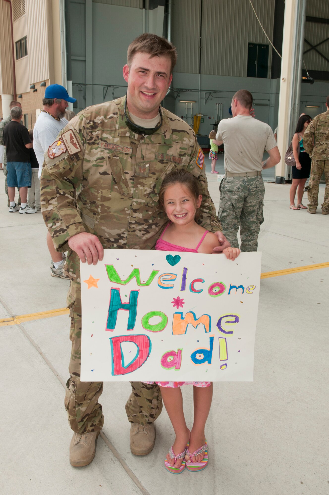 Tech. Sgt. Jeremy Fallecker, Flight Engineer with the 130th Airlift Wing, West Virginia Air National Guard, poses with his daughter after returning to Charleston, West Virginia from a 120-day deployment to Afghanistan and Kuwait in support of Operation Enduring Freedom.  U.S. Air Force Photo by TSgt Bryan G. Stevens [Photo Released]