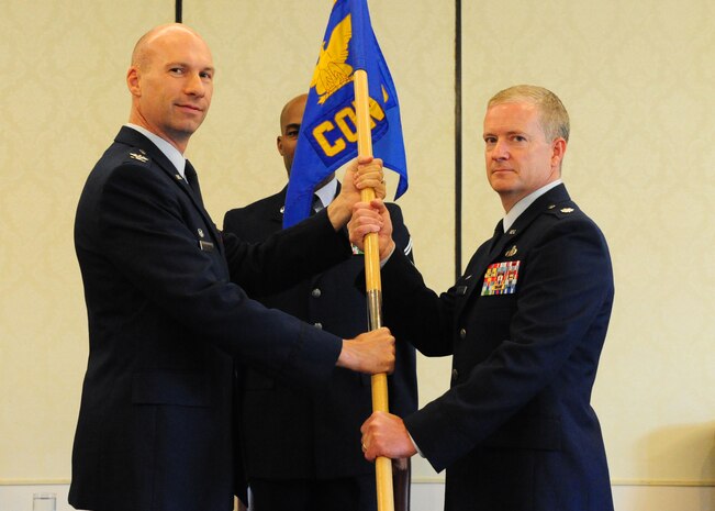 Colonel Justin Davey, 628th Mission Support Group commander, hands the guidon to Lt. Col. Dale Skinner, 628th Contracting Squadron incoming commander, during the 628th CONS Change of Command Ceremony at Joint Base Charleston - Air Base, S.C, July 16, 2012. The passing of the guidon symbolizes the changing of a command. (U.S. Air Force photo/ Airman 1st Class Chacarra Walker)