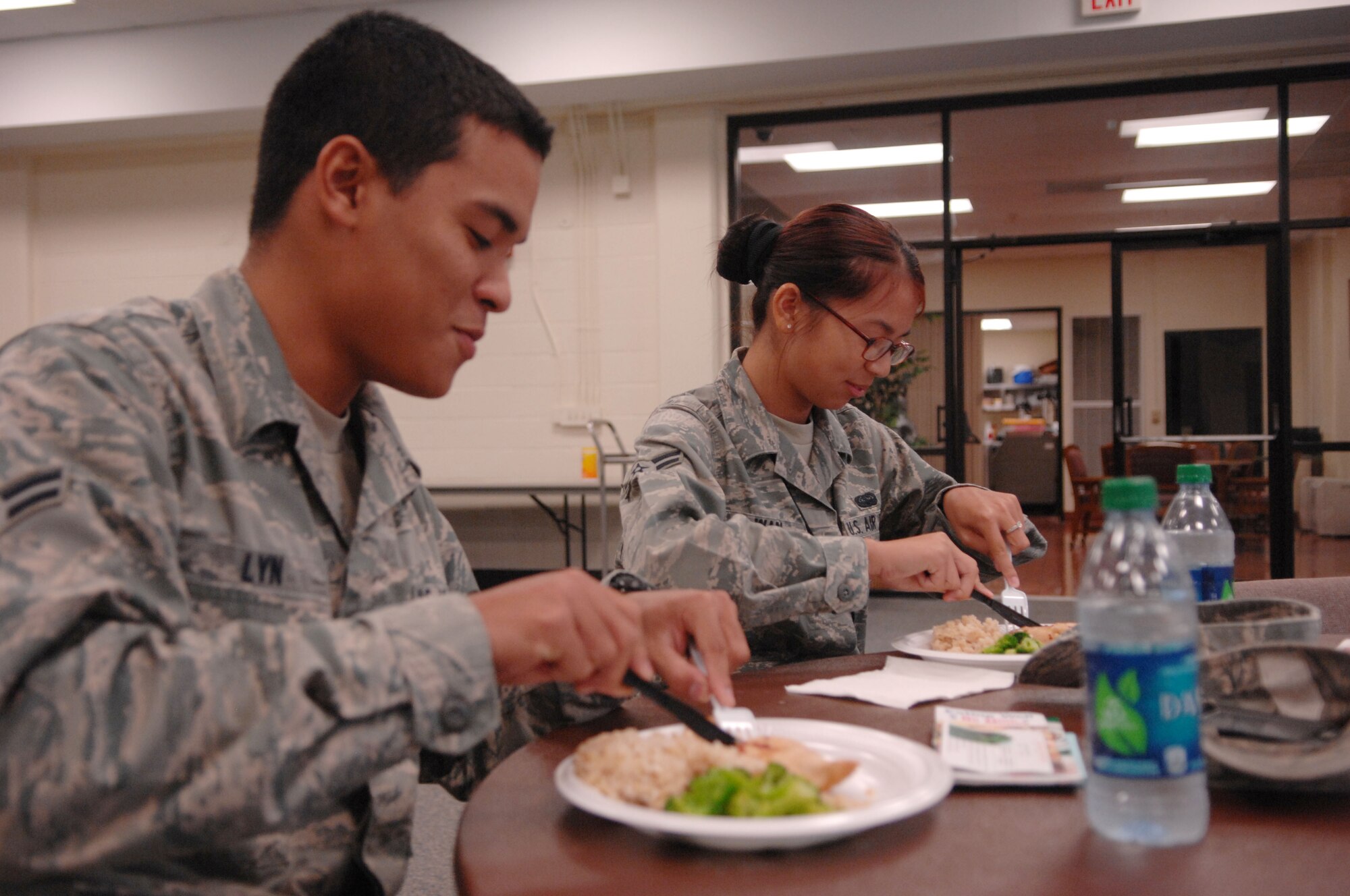 U.S. Air Force Airman 1st Class Josephine Wan, AFCENT/A-4 knowledge operations manager and Airman 1st Class Craig Lyn, 20th Force Support Squadron personnel journeyman, eat at a microwave cooking class for Airmen at the community center, Shaw Air Force Base, S.C., July 12, 2012.  The class provided Airmen with easy to cook recipes they can make in the dorms.(U.S. Air Force photo by Airman Nicole Sikorski/Released) 