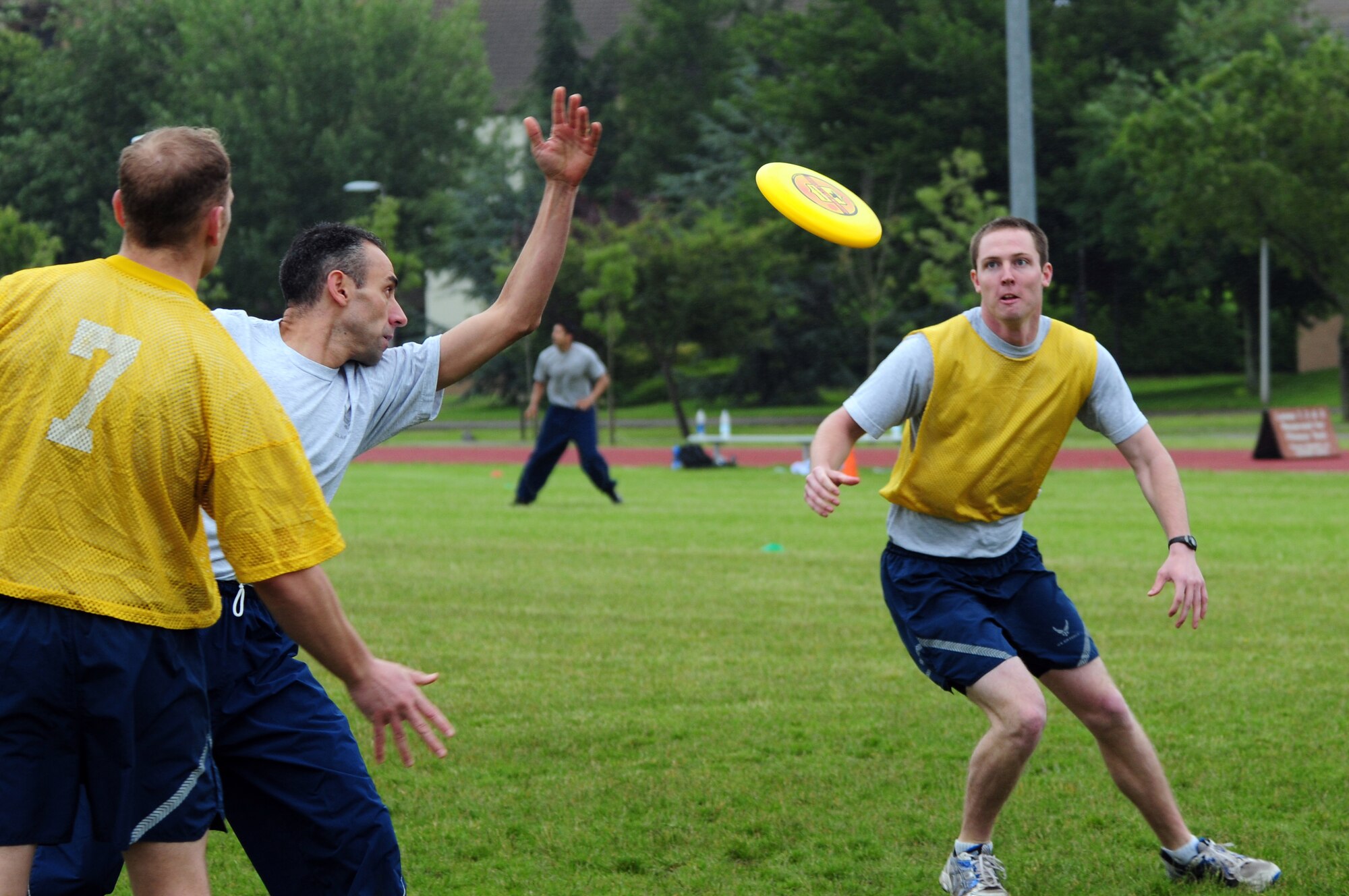 ROYAL AIR FORCE LAKENHEATH, England – Airman 1st Class Nathan Friederichs (right), 48th Medical Operations Squadron pediatric medical technician, receives a pass during an ultimate frisbee match during the Liberty Olympics July 13, 2012. The Liberty Olympics offered 48th Fighter Wing Airmen and their families a day of friendly competitions such as dodge ball, a 5K fun run, ultimate frisbee and other activities. (U.S. Air Force photo by Airman 1st Class Cory D. Payne)