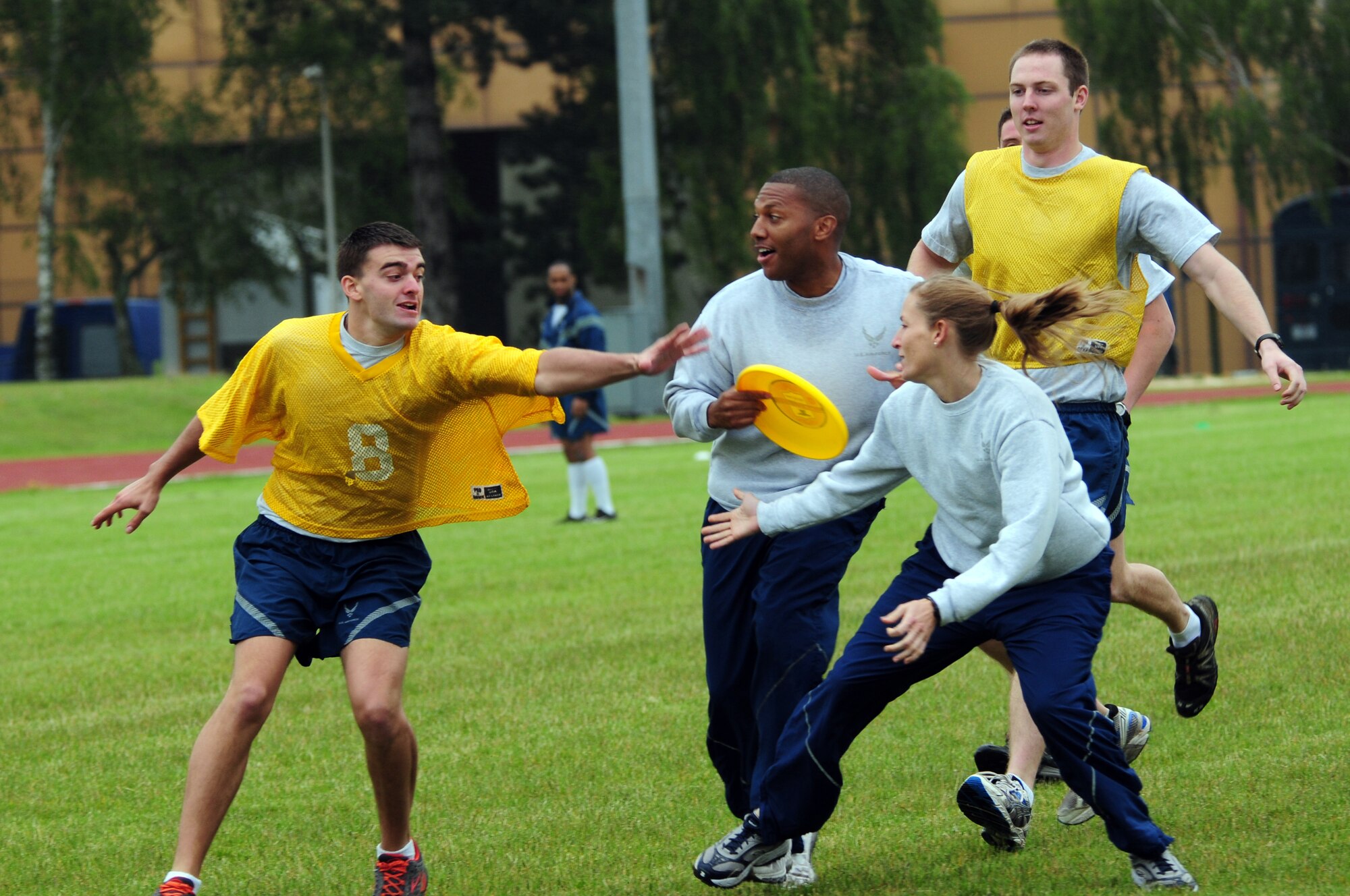 ROYAL AIR FORCE LAKENHEATH, England – Senior Master Sgt. Dwayne Gordon (center), 48th Public Affairs superintendant, prepares to make a pass while being covered by members of the 48th Medical Operations Squadron during an ultimate frisbee match during the Liberty Olympics July 13, 2012. The Liberty Olympics offered 48th Fighter Wing Airmen and their families a day of friendly competitions such as dodge ball, a 5K fun run, ultimate frisbee and other activities. (U.S. Air Force photo by Airman 1st Class Cory D. Payne)