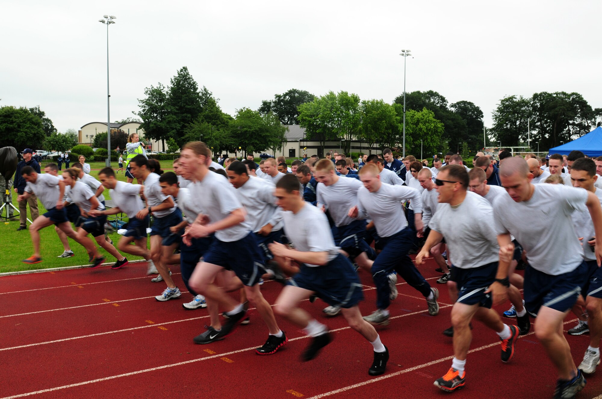 ROYAL AIR FORCE LAKENHEATH, England – Liberty Wing Airmen sprint off the starting line during a 5k fun run during the Liberty Olympics July 13, 2012. The Liberty Olympics offered 48th Fighter Wing Airmen and their families a day of friendly competitions such as dodge ball, a 5K fun run, ultimate frisbee and other activities. (U.S. Air Force photo by Airman 1st Class Cory D. Payne)