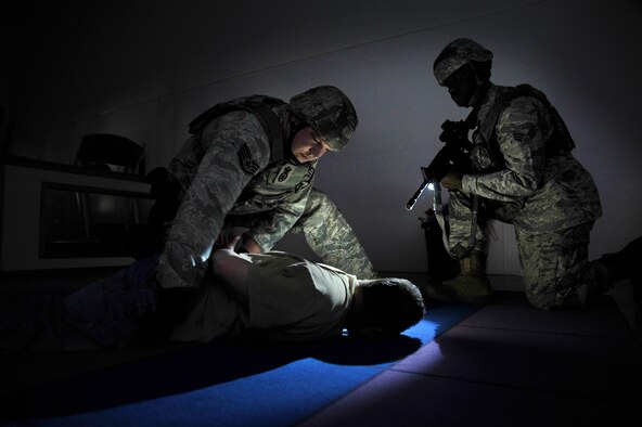 Members of the 35th Security Forces Squadron apprehend a simulated shooter during an Emergency Management Exercise at Misawa Air Base, Japan, July 17, 2012. The exercise tested emergency responder’s ability to coordinate accurate and timely response procedures to an active shooter scenario in a simulated environment. (U.S. Air Force photo by Staff Sgt. Nathan Lipscomb/Released)