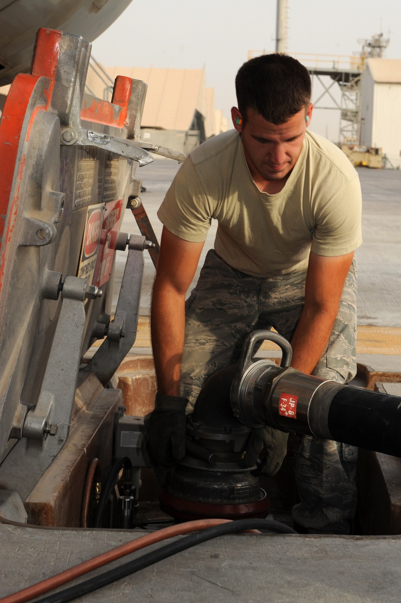 SOUTHWEST ASIA - U.S. Air Force Staff Sgt. Jason Drobish, 380th Expeditionary Logistics Readiness Squadron Petroleum, Oils and Lubricants flight fuels distribution supervisor, disconnects a hose from an in-ground fuel station July 16, 2012. Drobish, a Kennewick, Wash., native, is deployed from Barksdale Air Force Base, La. (U.S. Air Force photo/Master Sgt. Scott MacKay)