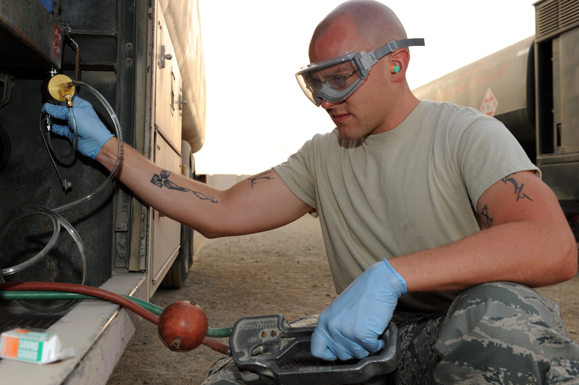 SOUTHWEST ASIA - U.S. Air Force Staff Sgt. Daniel Klinger, 380th Expeditionary Logistics Readiness Squadron Petroleum, Oils and Lubricants flight, pulls a fuel sample from a fuel truck July 16, 2012. Klinger, NCO in charge of the fuels laboratory, is a Tomball, Texas, native and is deployed from Eielson Air Force Base, Alaska. (U.S. Air Force photo/Master Sgt. Scott MacKay)