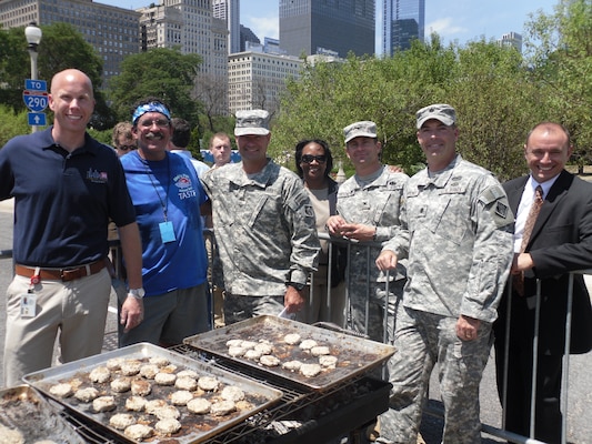 CHICAGO, Ill. -- From left, U.S. Army Corps of Engineers (USACE) Great Lakes and Mississippi River Interbasin Study (GLMRIS) Chicago Area Waterway System Project Manager Dave Wethington; Dirk's Fish and Gourmet Shop Chef Dirk Fucik; USACE Chicago District Commander Col. Frederic A. Drummond Jr.; USACE Great Lakes and Ohio River Division Regional Integration Team Civil Works Deputy Yvonne Prettyman; USACE Rock Island District Commander Col. Mark Deschenes, USACE Chicago District Deputy Commander Lt. Col. Jim Schreiner and GLMRIS Program Manager Dave Romano, Taste of Chicago, Grant Park, July 11, 2012.