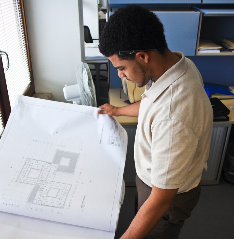 WIESBADEN, Germany -- Lucas Suarez, Advancing Minorities' Interest in Engineering (AMIE) intern, reviews some blueprints for a construction project in Israel while working with the Project Management department at the Amelia Earhart here, July 10, 2012. 