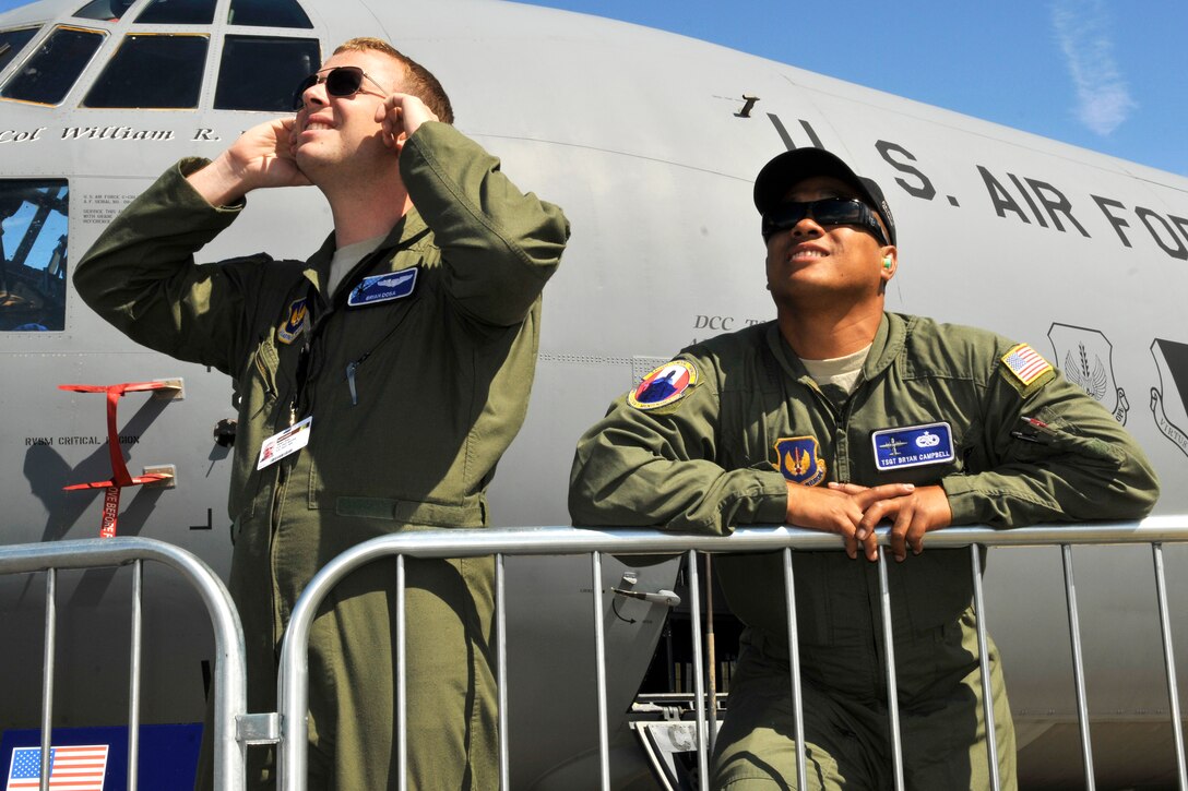 U.S. Air Force 1st Lt. Brian Dosa, left, and Air Force Tech. Sgt. Bryan Campbell watch an aerial demonstration during the Farnborough International Air Show in Farnborough, England, July 11, 2012. Dosa, a pilot, is assigned to the 37th Airlift Squadron, and Campbell, a flying crew chief, is assigned to the 86th Aircraft Maintenance Squadron.