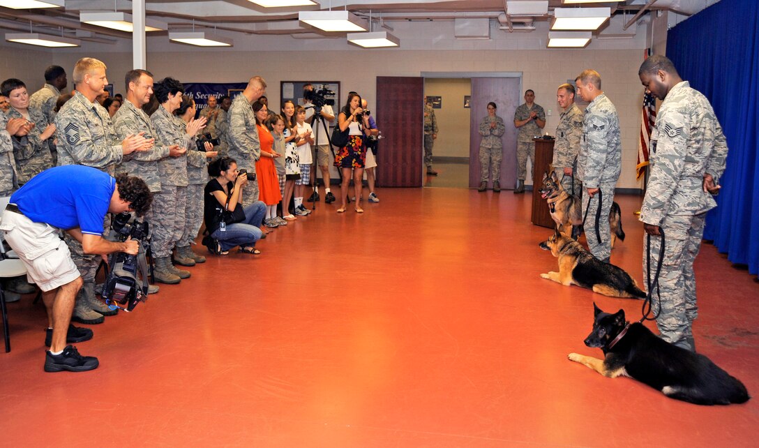 Members of the 6th Security Forces Squadron attend a retirement ceremony to honor military working dogs Conny, Jago and Harris on MacDill Air Force Base, Fla., July 12, 2012. Conny and Jago went home with their current handlers and Harris will live with a Vietnam veteran and his wife from Louisiana.