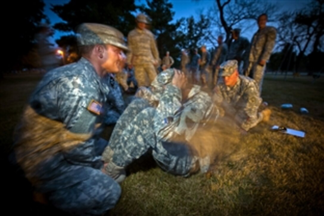 A National Guard soldier assigned to the 817th Sapper Company does sit-ups as part of the unit's first Sapper Stakes Competition in Jamestown, N.D., July 14, 2012.