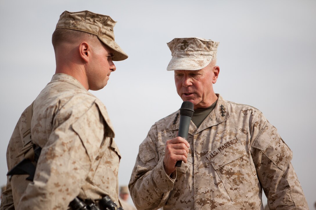 Commandant of the Marine Corps Gen. James F. Amos answers a question about future promotion opportunities from a 2nd Battalion, 5th Marine Regiment Marine serving at Combat Outpost Shir Ghazi, Afghanistan, July 17, 2012. General Amos and Sergeant Major of the Marine Corps Micheal P. Barrett addressed Marines and answered questions at six locations in Helmand province. They praised the Marines for the successes they’ve made in what was, only three years ago, one of the most volatile places in Afghanistan. Marines are now transferring security responsibilities to Afghan forces and transitioning into primarily an advisor role. 
