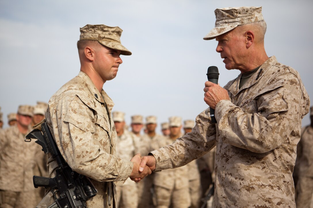 Commandant of the Marine Corps Gen. James F. Amos thanks a 2nd Battalion, 5th Marine Regiment Marine for his question at Combat Outpost Shir Ghazi, July 17, 2012. General Amos and Sgt. Maj. of the Marine Corps Micheal P. Barrett stopped at six locations in southern Afghanistan to meet and thank Marines for their service. Both leaders discussed the future of the Marine Corps as it begins to scale down in size from 202,000 Marines to 182,100 over the next four years. As the focus shifts away from prolonged combat operations in Afghanistan, the Marine Corps looks to be an expeditionary force in readiness in the Pacific. Marines will be deployed and stationed in Japan, Guam and Australia.