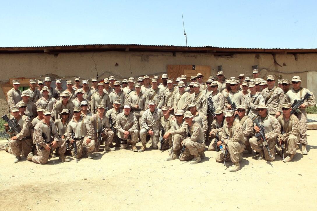 General James F. Amos, commandant of the Marine Corps, and Sgt. Maj. Micheal P. Barrett, sergeant major of the Marine Corps, take a group photo with Marines from 1st Battalion, 7th Marine Regiment, July 17, 2012. During their visit, Gen. Amos and Barrett spoke with leaders of 1st Bn., 7th Marines and took the opportunity to take pictures with Marines.