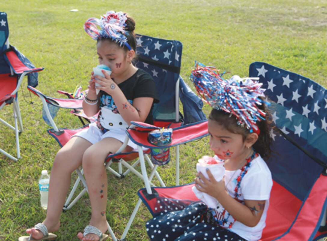 Jessenia Lozoya and Vangalise Viesca enjoy snow cones from one of the vendors at the Marine Corps Community Service's July Fourth celebration aborad Marine Corps Base Camp Lejeune. Their fathers are Marines deployed to Afghanistan with 3rd Battalion, 8th Marines. 

