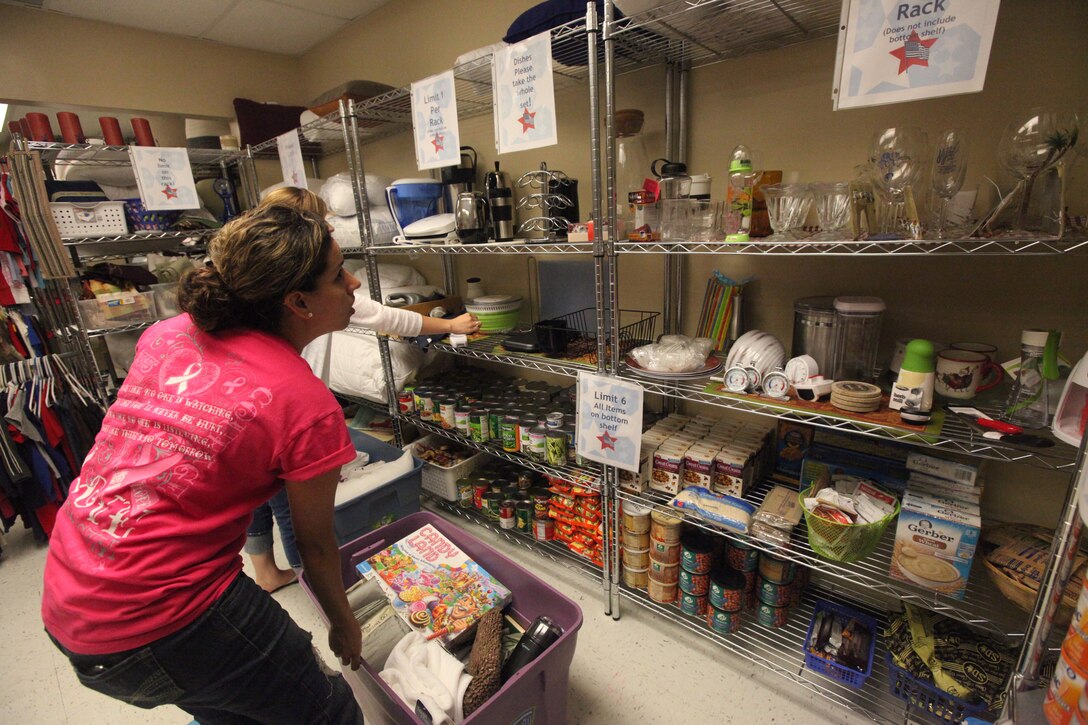 A military spouse scans the shelves for items to put in her tote during the Backdoor Boutique hosted at the Armed Services YMCA aboard Marine Corps Base Camp Lejeune’s Tarawa Terrace residential area July 14. The boutique is held Fridays at 9 a.m. and Saturdays at 8 a.m.