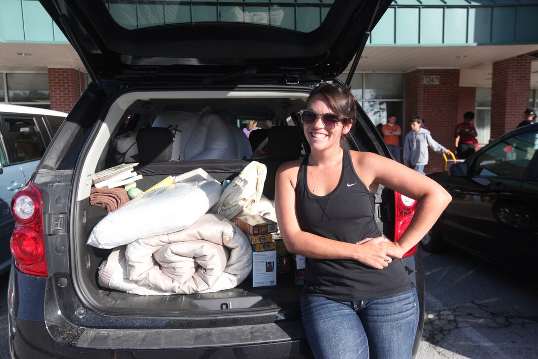 Becky Lee, a military spouse, stands by her trunk to after filling it with items she selected during the Backdoor Boutique hosted at the Armed Services YMCA aboard Marine Corps Base Camp Lejeune’s Tarawa Terrace residential area July 14. The money-saving event is open to active-duty sergeants and below, and their spouses.