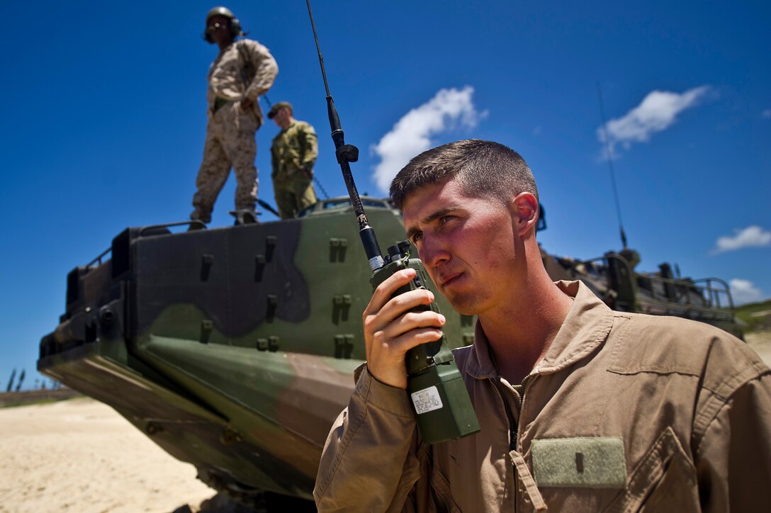 U.S. Marine Corps 2nd Lt. Kyle Durant, Amphibious Assault Vehicle Platoon commander, Combat Assault Company, 3rd Marine Regiment, Marine Corps Base Hawaii – Kane’ohe Bay, uses a radio to communicate with the USS Essex (LHD-2) from Pyramid Rock beach July 12, during Rim of the Pacific Exercise (RIMPAC) 2012. Approximately 2,200 troops from nine countries are part of the Combined Force Land Component Command, and will be conducting amphibious and land-based operations throughout the exercise in order to enhance mutual capabilities and joint interoperability.