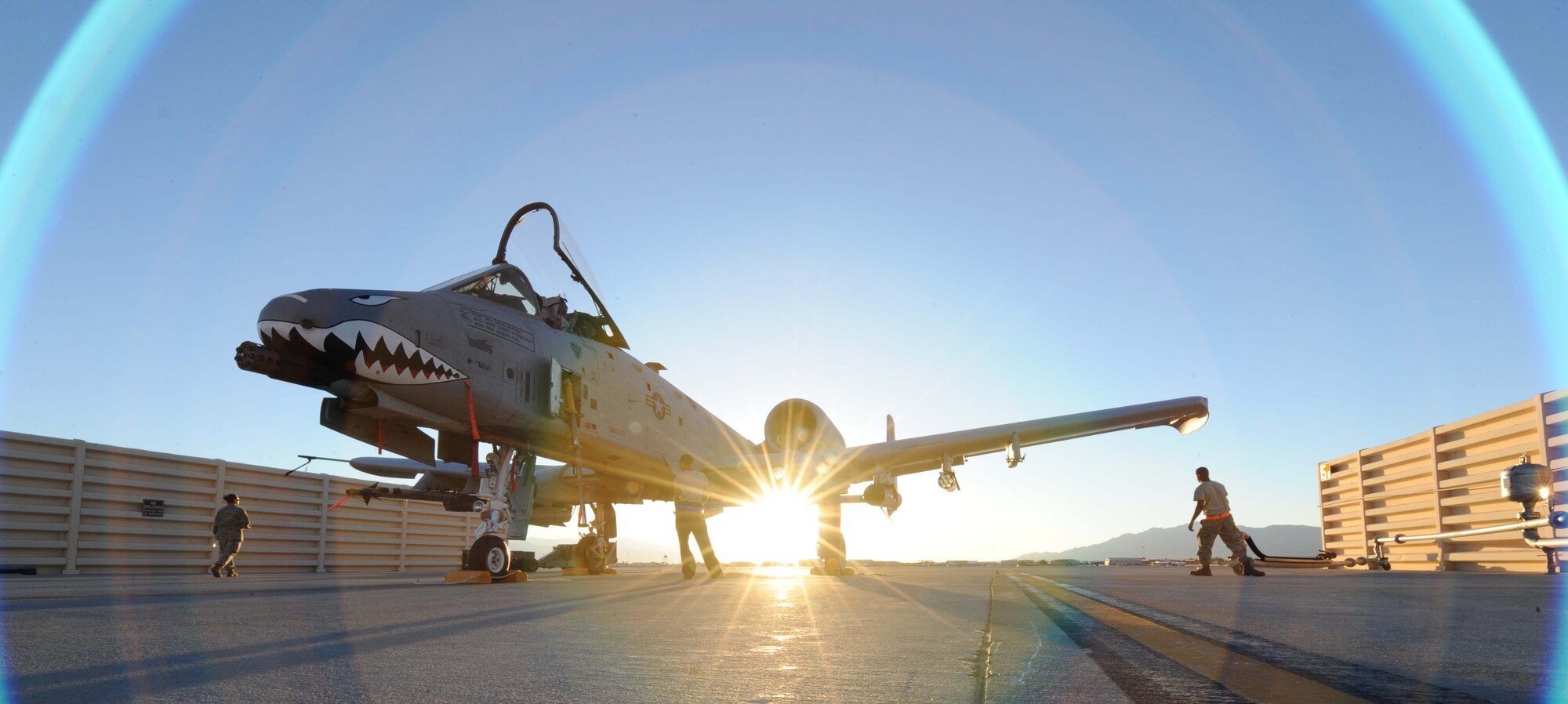 The sun sets July 16, 2012, as an A-10C Thunderbolt II sits on the ramp at Nellis Air Force Base, Nev.  Aircrew from the 23d Wing, 74th Fighter Squadron, at Moody Air Force Base, Ga., are flying missions from Nellis during exercise Red Flag 12-4.  The training sorties will unleash up to eight MK-82 bombs per day and as much as 5,000 rounds from the A-10's 30 mm cannons.  (U.S. Air Force photo by Master Sgt. Sonny Cohrs/Released)