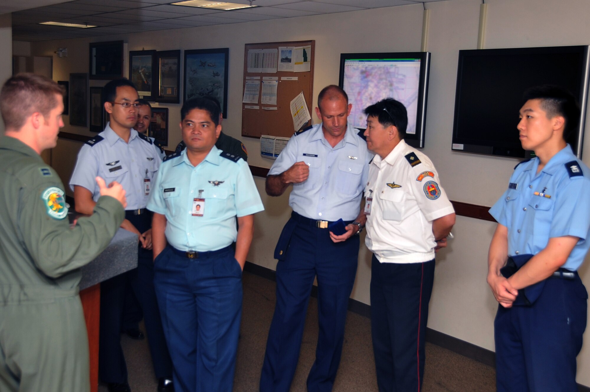 Capt. Clay Quinby (left) briefs international pilots on Osan Air Base operations, July 17, 2012. The pilots toured the 25th Fighter Squadron after arriving here as students of the Republic of Korea Joint Military University.  Quinby is an A-10 Thunderbolt II pilot with the 25th Fighter Squadron. (U.S. Air Force photo/Staff Sgt. Craig Cisek)