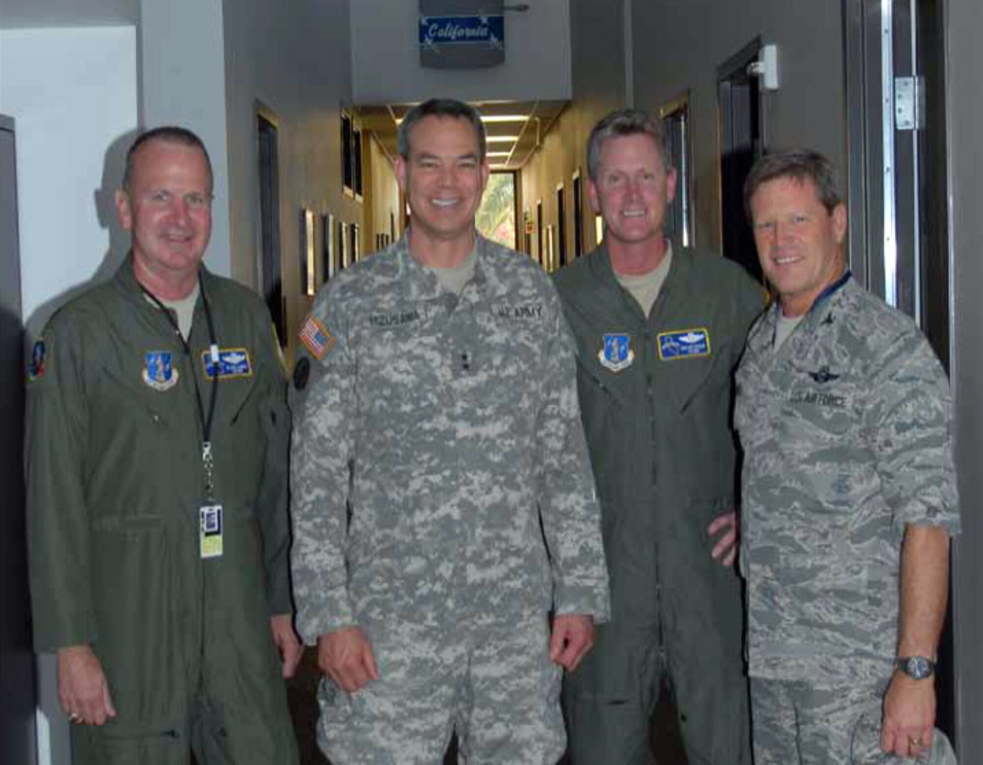 Pictured from left to right, Lt. Col. Blake Lamar, commander, 196th Reconnaissance
Squadron, Maj. Gen. Bert Mizusawa, Assistant to the Chairman, JCS, for Reserve Matters, Lt. Col Robert Patterson, vice commander 163d RW and Col. Randall Ball, commander 163d RW. Mizusawa attended a 163d RW capabilities briefing on the unit’s weapon platform, the MQ-1 Predator, on July 10. (U.S. Air Force photo by TSgt Neil Ballecer)