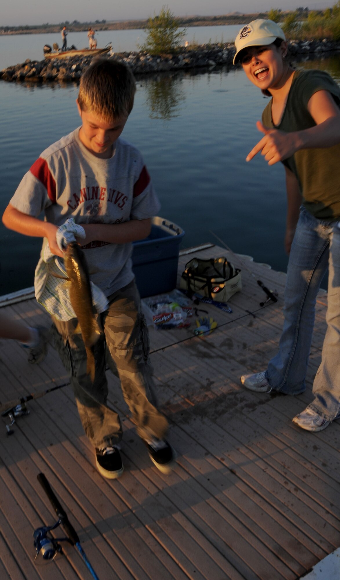 Senior Airman Lauren Runion, 366th LRS, cheers for Dylan Miller’s big catch, July 12 at Strike Dam marina. This particular bass tied for first place. (U.S. Air Force photo/Senior Airman Benjamin Sutton)