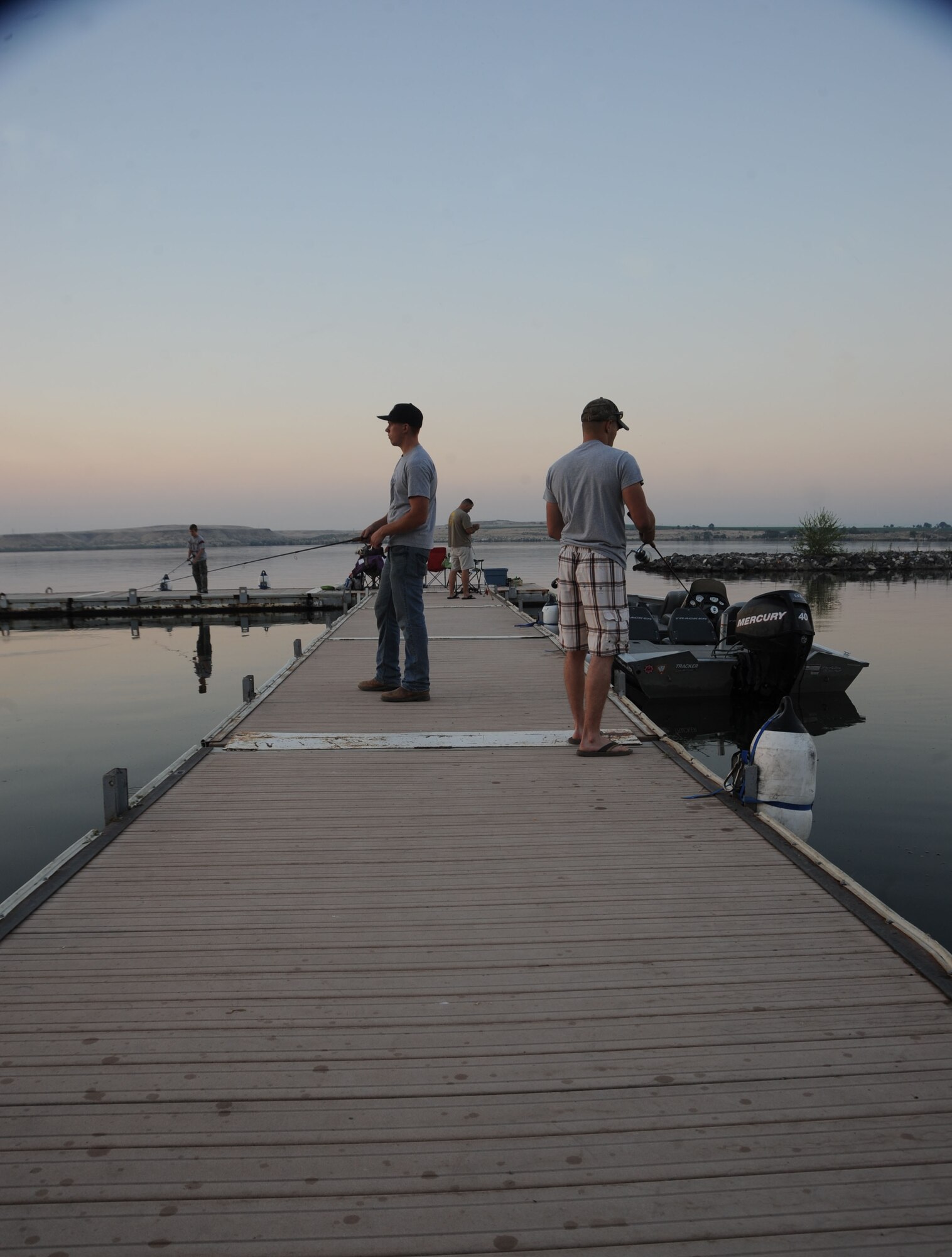 Airman 1st Class Joseph Stevenson and Senior Airman Matthew Wilkey, with the 366th Logistics Readiness Squadron, hope to temp the fish to bite while competing in the fourth annual bass tournament, July 12 at Strike Dam marina. Not even numerous tiny gnats flying around their faces could keep the anglers from concentrating on their individual goals of catching the biggest bass. (U.S. Air Force photo/Senior Airman Benjamin Sutton)