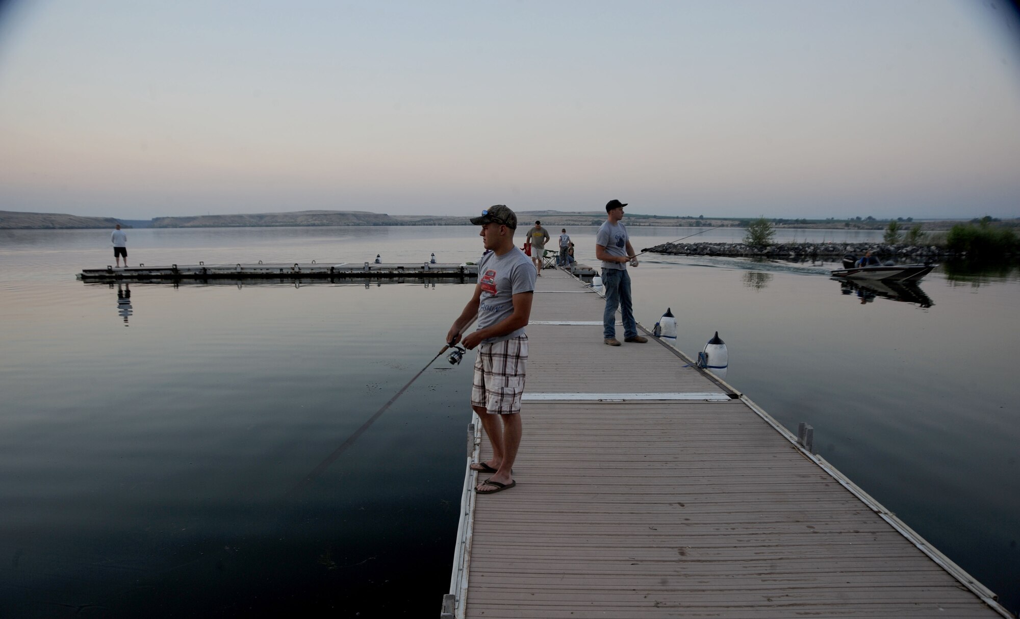Airman 1st Class Joseph Stevenson and Senior Airman Matthew Wilkey, with the 366th Logistics Readiness Squadron, concentrate on their lures while competing in the fourth annual bass tournament, July 12 at Strike Dam marina. The event is a squadron function geared toward boosting morale. (U.S. Air Force photo/Senior Airman Benjamin Sutton)