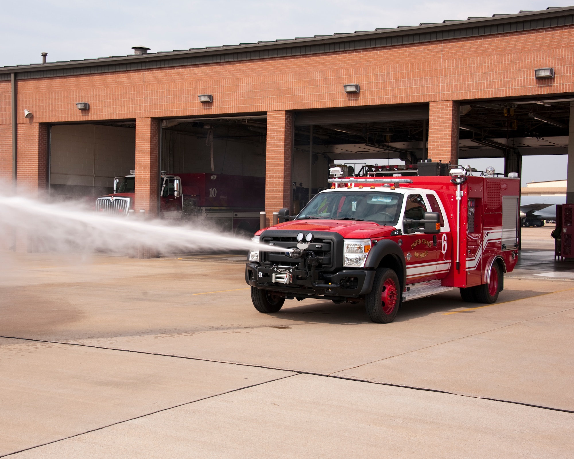 The Rapid Intervention Vehicle (RIV) is the newest addition to the Air Force crash response fleet.  Sheppard Air Force Base firefighter, Carl Lamb, operates the ultra high pressure turret mounted on the front of the bumper on 12 July 2012. (US Air Force Danny Webb)
