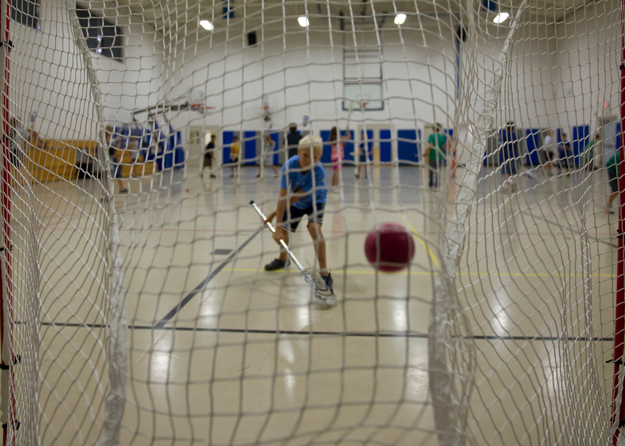 Will Hankins, 8, son of Lt. Col. Dawn Hankins, 49th Wing staff judge advocate, shoots a lacrosse ball into a goal during a Sideline Sports Camp at Holloman Air Force Base, N.M., July 13. Hankins was one of more than 20 children of Team Holloman who participated in the camp, which aims to expand each participant’s understanding of non-traditional sports, improve physical fitness, and develop an appreciation for the various sports offered. Each day of the camp, the Sideline Sports instructors introduced a new sport to the participants, including ultimate frisbee, handball, badminton, fencing and lacrosse. (U.S. Air Force photo by Senior Airman Siuta B. Ika/Released)