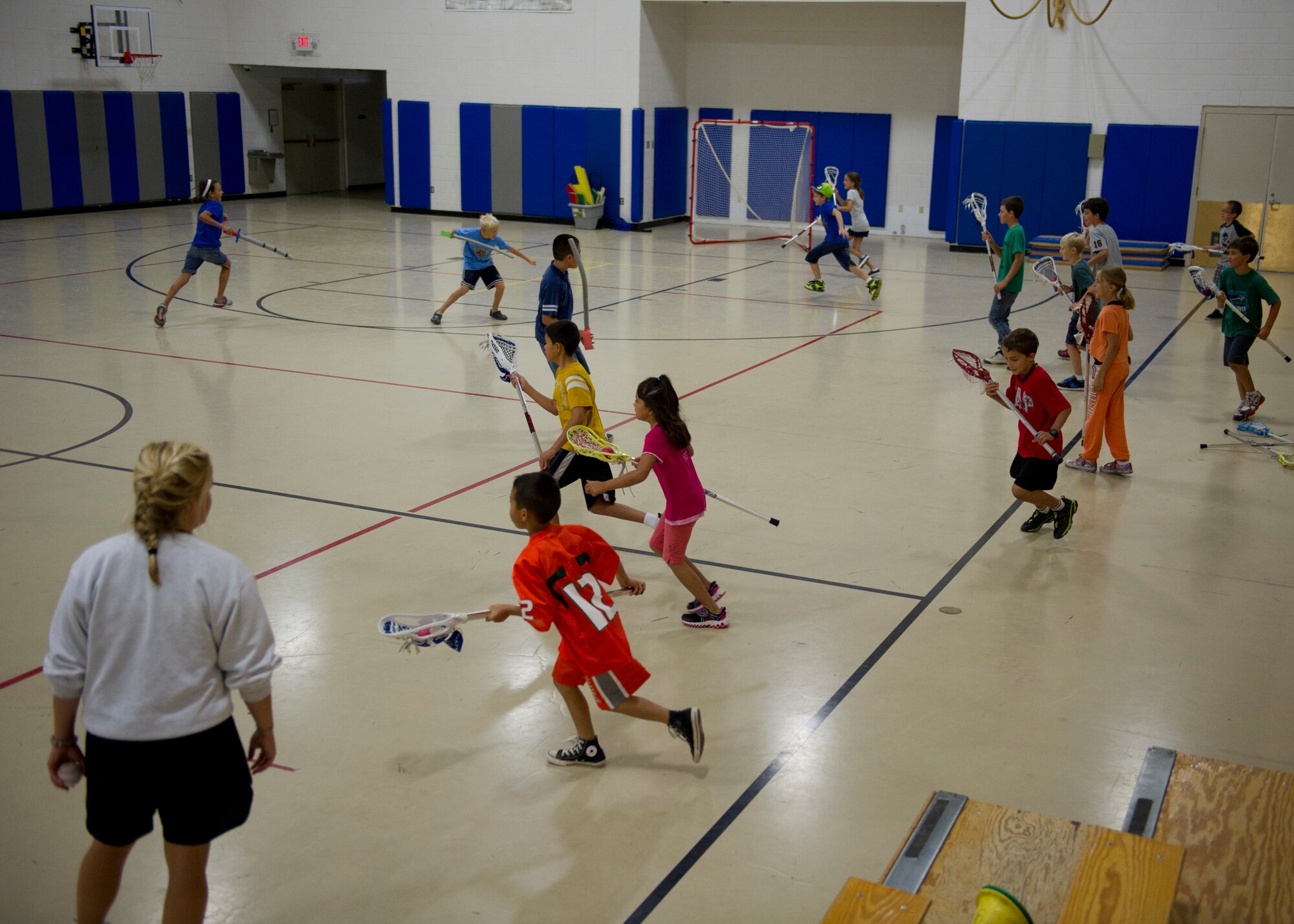 Children play lacrosse during a Sideline Sports Camp at Holloman Air Force Base, N.M., July 13. The goal of the camp, which took place July 9-13, is to expand each participant’s understanding of non-traditional sports, improve physical fitness, and develop an appreciation for the various sports offered. Each day of the camp, the Sideline Sports instructors introduced a new sport to the participants, including ultimate frisbee, handball, badminton, fencing and lacrosse. (U.S. Air Force photo by Senior Airman Siuta B. Ika/Released)