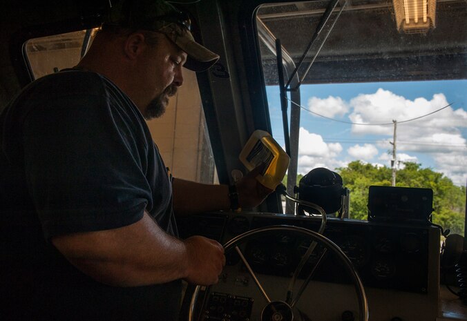 Thomas White, 628th Logistics Readiness Squadron Port Operations maintenance contractor, fills a hydraulic steering system, July 16, 2012 at Joint Base Charleston – Weapons Station. Port Operations is responsible for the maintenance of six boats at JB Charleston. Four of those boats are 27-foot long Sea Arks, designated as Harbor Security Boats used by the 628th Security Forces Squadron.
