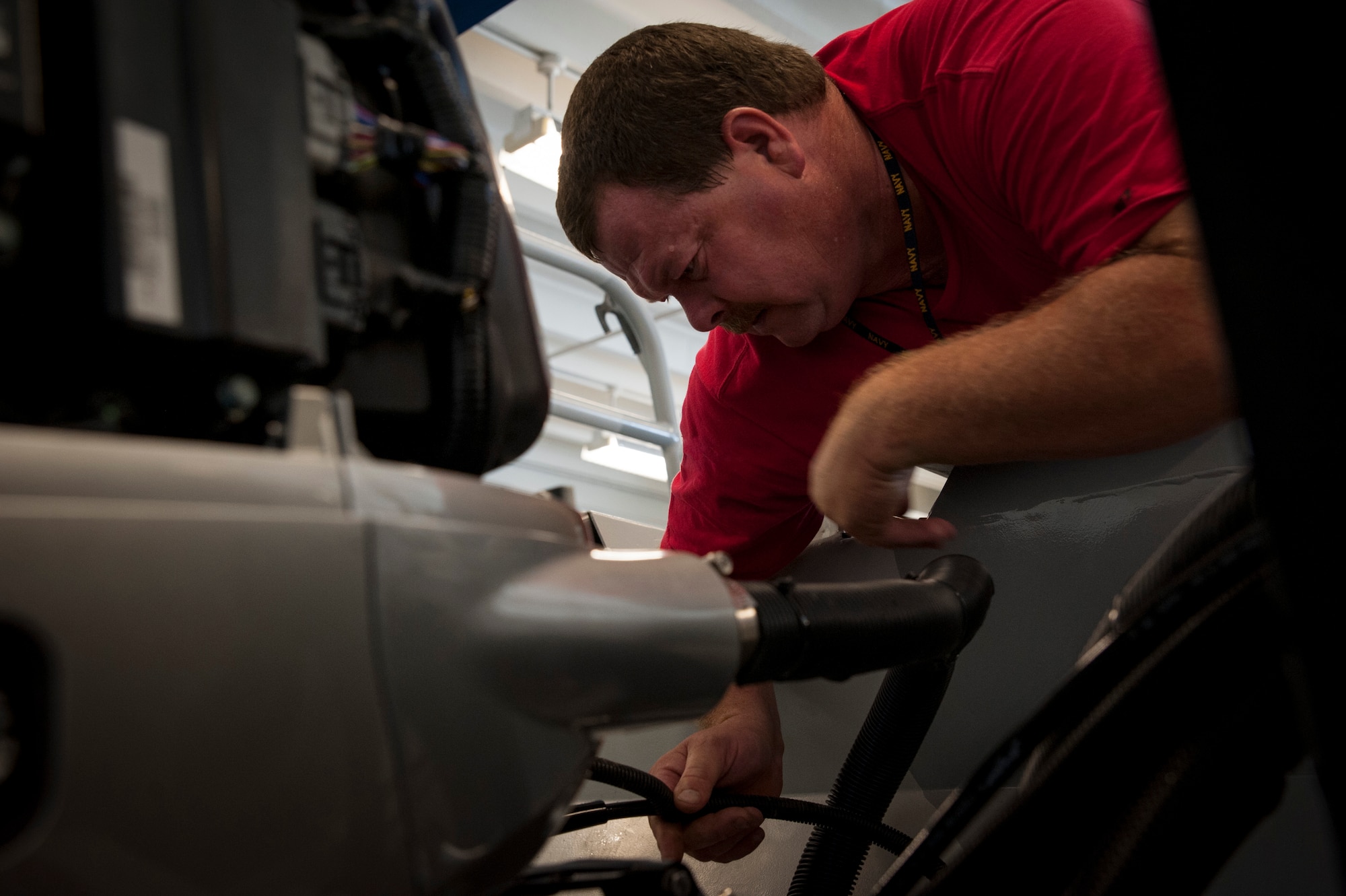 Frank Gregory, 628th Logistics Readiness Squadron Port Operation maintenance contractor, bleeds air out of a newly installed hydraulic steering system in a Harbor Security Boat, July 16, 2012 at Joint Base Charleston – Weapons Station. Port Operations is responsible to the JB Charleston commander for the overall safety of ship movements within the JB Charleston – Weapons Station port, which includes Wharf Alpha, Pier Bravo, Pier Charlie, Pier Edwards and the TC Dock. (U.S. Air Force photo by Airman 1st Class Ashlee Galloway)