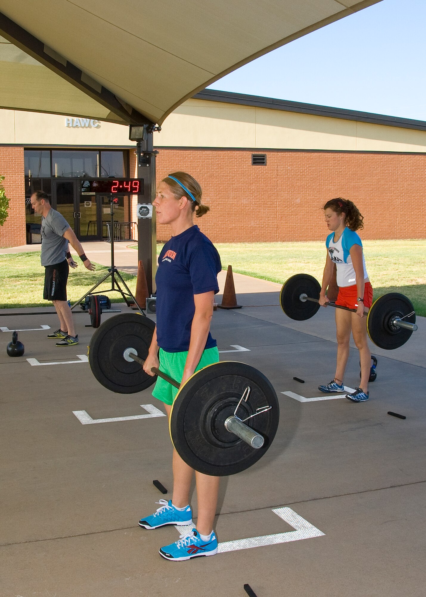 Capt. Patricia Cassidy (center) performs deadlifts during the July 18, 2012 CrossFit competition at the Pitsenbarger Fitness Center. The deadlift accounted for 50 repetitions of the total 391 repetitions in the workout done in honor of Capt. Francis Imlay. 